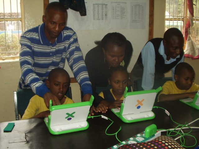 Three Kenyan teachers from the Imani primary school in Kibwezi, Kenya teach OLPC to their students.
