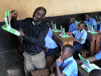 2017-11 Emmanuel (Care for Kids) teaching use of XO in Rwanda.JPG
